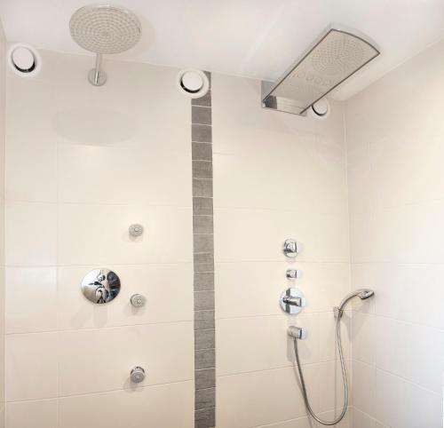 a shower with a shower head in a bathroom at Sun Valley - Wildschönau in Auffach