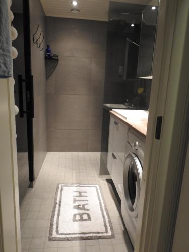 a bathroom with a washer and dryer in a kitchen at Scandinavian Sleeping & Living in Turku