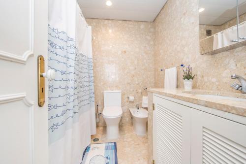 une salle de bains avec toilettes et lavabo dans l'établissement Av. 1º de Maio, à Costa da Caparica