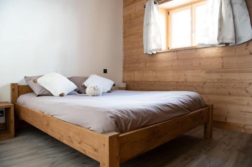 a bed with a teddy bear sitting on top of it at Chalet Victoire in Chamonix-Mont-Blanc