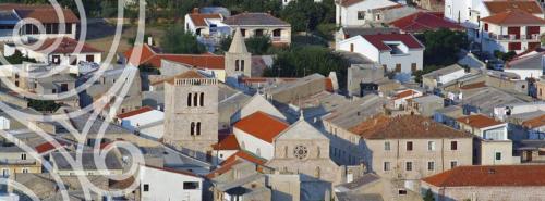 an aerial view of a town with a church at Moon Stone Residence Pag in Pag