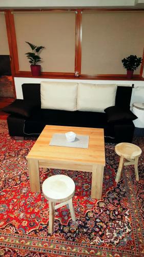 a living room with a couch and a table and two stools at Martin´s House in Martin