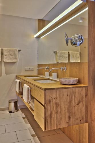 a bathroom with a sink and a mirror at Residence Zur Post Sexten in Sesto