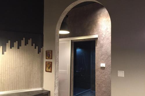 a hallway with an archway leading to a bathroom at Design Atelier in Sarajevo