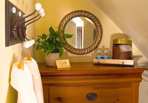 a mirror on top of a wooden dresser in a bathroom at Lyndon House Bed & Breakfast in Lexington