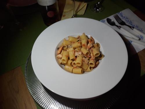 a bowl of food on a white plate on a table at Appartamento in centro storico in Asti