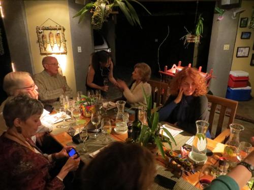 a group of people sitting around a table at Pura Vida Hotel in Alajuela City