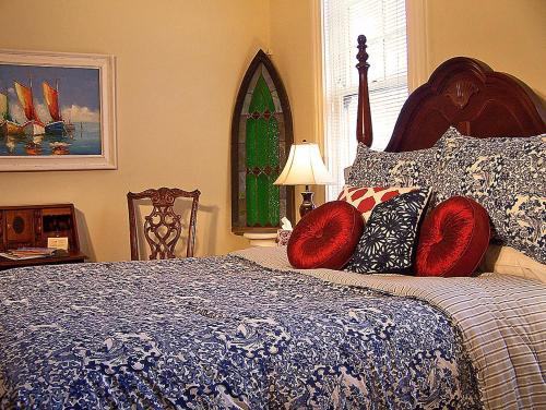 a bedroom with a large bed with red pillows at Lyndon House Bed & Breakfast in Lexington