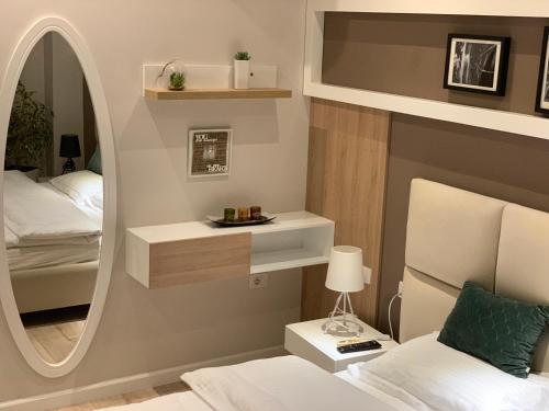 a bedroom with a large mirror and a bed at Haris Apartment Tirana no.2 in Tirana