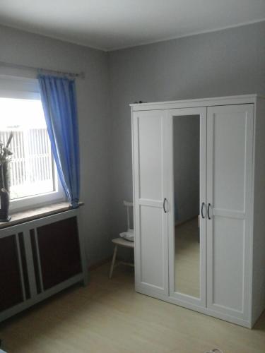 a room with a white cabinet and a window at Reitbergs Nest in Eugendorf