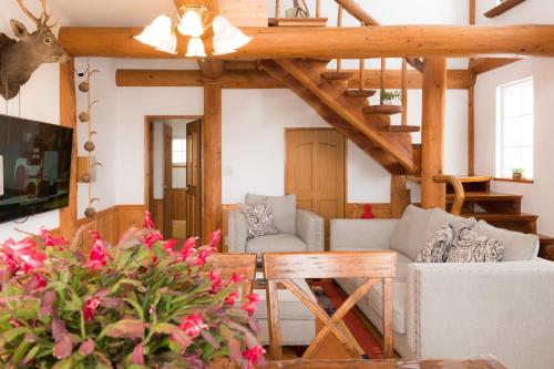 a living room with a couch and a table at Sapporo Luxury Log House 5Brm max 18ppl 4 free parking in Sapporo