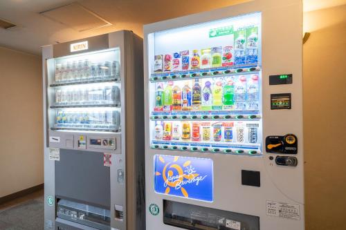 a vending machine filled with drinks and soda at Hotel Green Park Suzuka in Suzuka