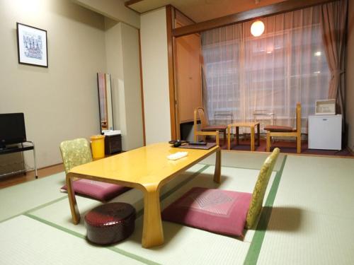 
a living room filled with furniture and a tv at Hotel Harumoto in Nikko
