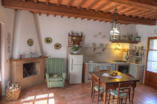 una cucina con tavolo e camino di La Casa Di Nonna Lucia a Montescudaio