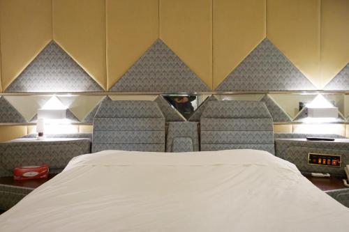 a hotel room with a bed and chairs at China HK Motel in Hong Kong
