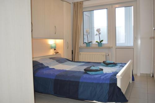 A bed or beds in a room at Residentie Paola