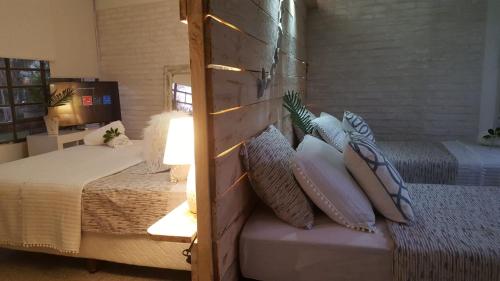 a bedroom with a bed with pillows on it at Bidieen Inn Uruguay in Carrasco