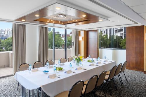 a conference room with a long white table and chairs at View Melbourne in Melbourne