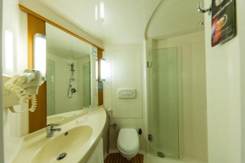 a bathroom with a sink and a shower and a toilet at ibis Chennai City Centre - An Accor Brand in Chennai