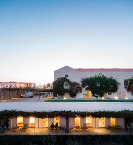 a building with tables and chairs in front of it at Flattered to be in Algarve in Tavira