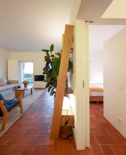 a living room with a staircase leading to a bedroom at Flattered to be in Algarve in Tavira
