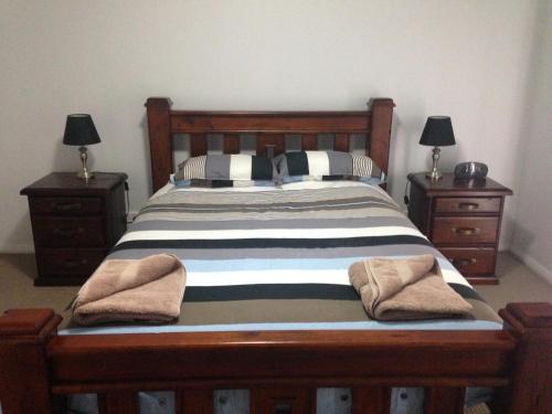 a bedroom with a bed and a dresser at Griffith Prestige Apartments in Griffith