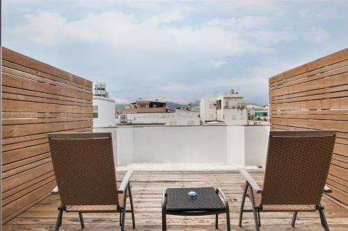 two chairs and a table on a balcony at Taitung Spring Homestay B&B in Taitung City