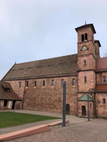 a large brick building with a clock tower at Hotel-Restaurant Gasthof zum Schützen in Baiersbronn