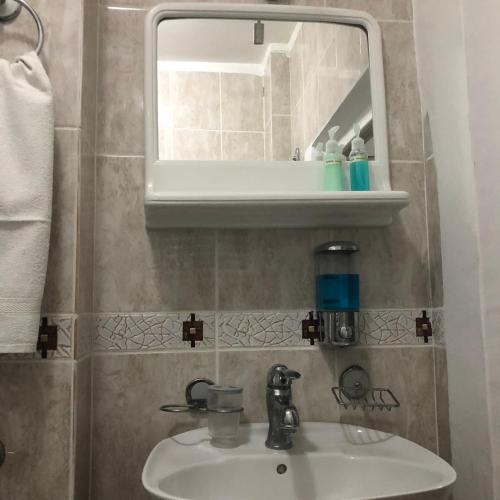 a bathroom with a sink and a mirror at Apartment Velago in Zlatibor