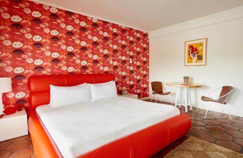 a red bed in a room with a red wall at Austin Motel in Austin
