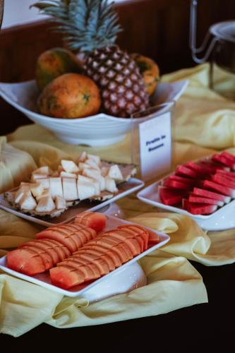 a table topped with plates of food and bowls of fruit at Panja Resort Palawan in Puerto Princesa City
