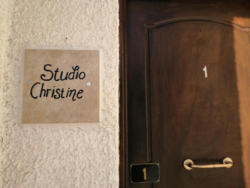 a door with a sign that reads studio christmas at Castle By The Sea in Artemida