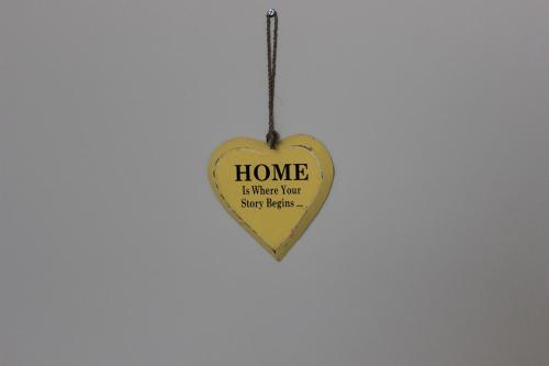 a wooden heart shaped ornament with home is where there are your feelings at Adi Bali Homestay in Uluwatu