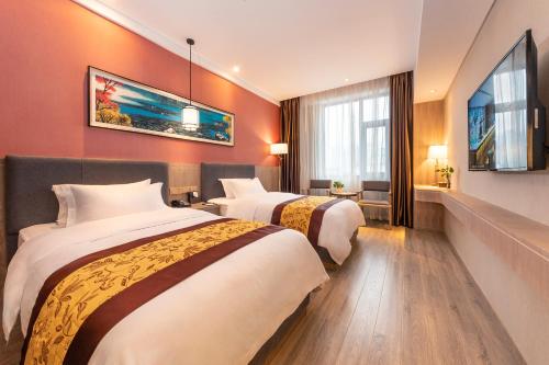 Postel nebo postele na pokoji v ubytování Chengdu Jiuzhaigou Hotel