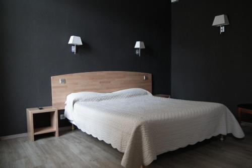 Postel nebo postele na pokoji v ubytování Hôtel la Guimbarde