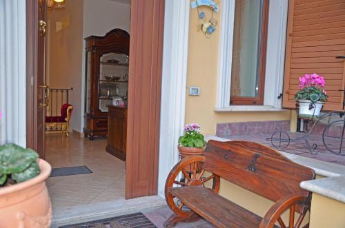 a porch with a wooden bench in a house at B&B Casa Cavour in San Benedetto del Tronto