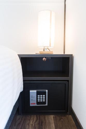 a bedroom with a bed with a television and a sink at JINYA Fujikawaguchiko in Fujikawaguchiko