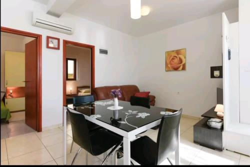 a dining room and living room with a table and chairs at Apartments Rena & Filip, by the beach in Preko