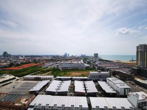 an aerial view of a city with buildings and the ocean at ExcluSuites Malacca @ The Wave Residence in Melaka