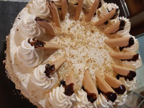 a cake with whipped cream and sticks on it at Gasthof Klug zum Ehrensepp in Modriach