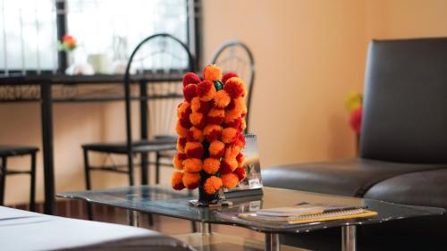a vase filled with fruit on a table at Hotel Mountain View - Lakeside Pokhara in Pokhara