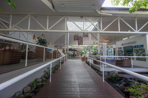 a building with a hallway with plants in it at Sonia's At Ramada Resort Free Wifi in Port Douglas