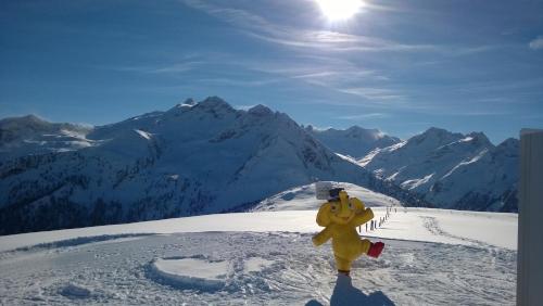 a yellow fire hydrant standing on top of a snow covered mountain at Waidmannsruh Appartements in Gerlos