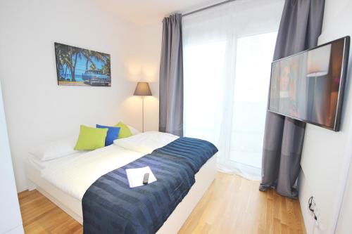 a bedroom with a bed and a large window at Apart Hotel Messe Munich - my room Apartments in Munich