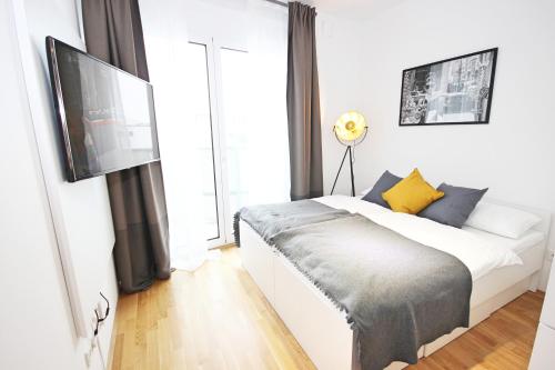 a bedroom with a bed and a large window at Apart Hotel Messe Munich - my room Apartments in Munich