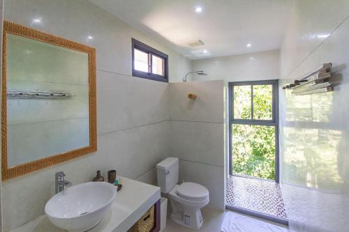 a bathroom with a sink and a toilet and a window at Stunning sea view villa Lamai Koh Samui in Lamai