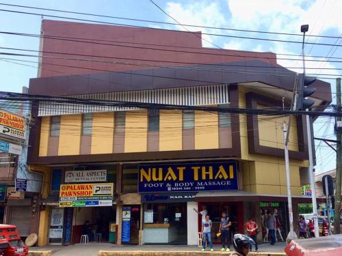 a building with a nut thai sign on a street at VL Garden Suites in Tagbilaran City