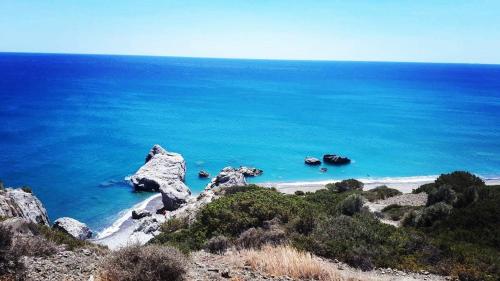 a view of a beach with rocks in the water at Orionas in Tsoútsouros