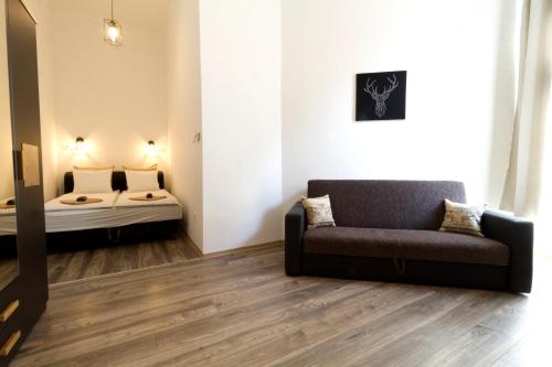 a living room with a couch and a bed at Karikum Large in Budapest