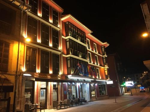 a building on a city street at night at Gran Hotel Paraiso in Llanes